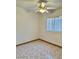 This bedroom has tile floors, neutral walls, a ceiling fan, and a window for natural light at 2621 Blue Reef Dr, North Las Vegas, NV 89032