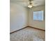 This bedroom has tile floors, neutral walls, a ceiling fan, and a window for natural light at 2621 Blue Reef Dr, North Las Vegas, NV 89032