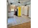 Well-lit kitchen featuring tile flooring, light wood cabinetry, and modern appliances at 2621 Blue Reef Dr, North Las Vegas, NV 89032