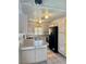 Well-lit kitchen featuring tile flooring, light wood cabinetry, and modern appliances at 2621 Blue Reef Dr, North Las Vegas, NV 89032