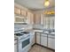 This kitchen features a gas range, tile floor, and updated lighting at 2621 Blue Reef Dr, North Las Vegas, NV 89032