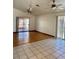 Bright living room featuring a hardwood floor, ceiling fans, and a sliding glass door at 2621 Blue Reef Dr, North Las Vegas, NV 89032