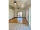 Bright living room featuring a hardwood floor, ceiling fans, and a sliding glass door at 2621 Blue Reef Dr, North Las Vegas, NV 89032