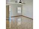 This living room features tile floors and a ceiling fan at 2621 Blue Reef Dr, North Las Vegas, NV 89032