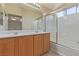 Bathroom with double sink vanity and shower-over-tub with glass doors at 3037 Austin Pale Ave, North Las Vegas, NV 89081