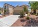 Inviting curb appeal with desert landscaping, long driveway, and a two-car garage at 3037 Austin Pale Ave, North Las Vegas, NV 89081