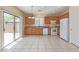Bright kitchen with sliding glass door access to backyard, tiled floors and wood cabinets at 3037 Austin Pale Ave, North Las Vegas, NV 89081