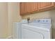 Functional laundry room with upper cabinets, a front load washer and dryer at 3037 Austin Pale Ave, North Las Vegas, NV 89081