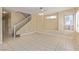 Expansive living area with tile floors, a staircase, and natural light streaming through windows at 3037 Austin Pale Ave, North Las Vegas, NV 89081
