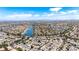 Extensive aerial view of a residential community with a lake and houses with red-tiled roofs at 3151 Soaring Gulls Dr # 2121, Las Vegas, NV 89128
