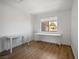 Clean bedroom with wood-look floors, ample natural light from window, and versatile workspace at 3151 Soaring Gulls Dr # 2121, Las Vegas, NV 89128