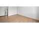 A bedroom with a full length mirror, white walls and wood-look floors at 3151 Soaring Gulls Dr # 2121, Las Vegas, NV 89128