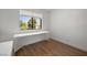Bright bedroom features wood-look flooring, a workspace, and natural light from a large window at 3151 Soaring Gulls Dr # 2121, Las Vegas, NV 89128