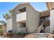 Condo featuring a private balcony, stairs, desert landscaping, and neutral stucco facade at 3151 Soaring Gulls Dr # 2121, Las Vegas, NV 89128