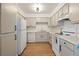 Clean kitchen features white appliances and cabinets with black pulls at 3151 Soaring Gulls Dr # 2121, Las Vegas, NV 89128