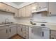 Functional kitchen featuring white appliances, laminate countertops, and ample cabinet storage space at 3151 Soaring Gulls Dr # 2121, Las Vegas, NV 89128