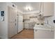 Bright kitchen with full-size appliances, white cabinetry, and durable laminate countertops at 3151 Soaring Gulls Dr # 2121, Las Vegas, NV 89128