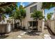 A low-maintenance backyard featuring desert landscaping, trees, privacy fencing and a sliding glass door entry at 3209 Cheltenham St, Las Vegas, NV 89129