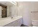 Bathroom features a white vanity with chrome fixtures, framed mirror and glass enclosed tiled shower at 3209 Cheltenham St, Las Vegas, NV 89129