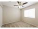 Bedroom with a ceiling fan, carpet flooring, and a large window at 3209 Cheltenham St, Las Vegas, NV 89129