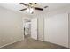 Cozy bedroom with plush carpet, ceiling fan, and a large sliding door closet at 3209 Cheltenham St, Las Vegas, NV 89129