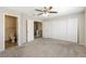 Spacious bedroom featuring large closets, neutral carpet, ceiling fan and ensuite bathroom at 3209 Cheltenham St, Las Vegas, NV 89129