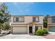 Inviting two-story home featuring a two-car garage, neutral stucco, and well-maintained landscaping at 3209 Cheltenham St, Las Vegas, NV 89129