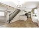 Open-concept kitchen with granite countertops, white cabinetry, stainless appliances and adjacent staircase at 3209 Cheltenham St, Las Vegas, NV 89129