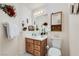 Bright bathroom with a wood vanity, decorative mirror and a modern comfort-height toilet at 3231 Rebel Ave, Pahrump, NV 89048