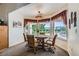 Cozy breakfast nook with table, chairs and bright windows offering picturesque outdoor views at 3231 Rebel Ave, Pahrump, NV 89048