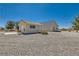 Expansive property featuring a charming single-story home with a detached garage and low-maintenance desert landscaping at 3231 Rebel Ave, Pahrump, NV 89048