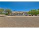 Stunning single-story home with lush landscaping, a circular driveway, and a charming front entrance at 3231 Rebel Ave, Pahrump, NV 89048