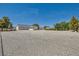 View of expansive property featuring a charming single-story home, detached garage, and low-maintenance gravel landscaping at 3231 Rebel Ave, Pahrump, NV 89048