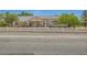Charming single-story home with a white fence, gravel driveway, and mature trees providing shade and curb appeal at 3231 Rebel Ave, Pahrump, NV 89048