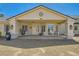 Inviting front entrance featuring a covered porch with columns, seating, and decorative plants creating a welcoming space at 3231 Rebel Ave, Pahrump, NV 89048