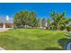 Lush green lawn in the front yard of a well-maintained home, framed by mature trees and manicured shrubbery at 3231 Rebel Ave, Pahrump, NV 89048
