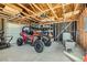 A garage filled with a UTV and tools showing framing, rafters, and storage shelves at 3231 Rebel Ave, Pahrump, NV 89048