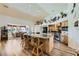 Spacious kitchen with wood cabinets, large island with seating, granite countertop, and adjacent breakfast nook at 3231 Rebel Ave, Pahrump, NV 89048