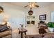 Spacious living room featuring neutral carpeting, ceiling fan, and natural lighting at 3231 Rebel Ave, Pahrump, NV 89048