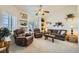 Living room featuring neutral carpet, plantation shutters, and built-in shelves at 3231 Rebel Ave, Pahrump, NV 89048