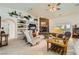 Cozy living room with a stone fireplace, built-in shelving, comfortable seating, and natural light creating a warm ambiance at 3231 Rebel Ave, Pahrump, NV 89048