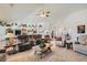Spacious open-concept living room with vaulted ceilings, comfortable seating, and seamless flow to the kitchen and dining areas at 3231 Rebel Ave, Pahrump, NV 89048