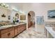 Luxurious bathroom boasts double sinks, granite countertops, arched doorways, and tile flooring at 3231 Rebel Ave, Pahrump, NV 89048