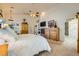Bright main bedroom with plush carpet, decorative fireplace, large dresser and doorway to bathroom at 3231 Rebel Ave, Pahrump, NV 89048