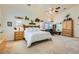 Main bedroom features a king bed, bright windows, plush carpet, high ceilings, and decor shelving at 3231 Rebel Ave, Pahrump, NV 89048