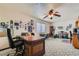 Spacious office area with a ceiling fan, a large desk, and natural light streaming through the window at 3231 Rebel Ave, Pahrump, NV 89048