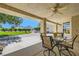 Inviting covered patio with a ceiling fan, table, and chairs, perfect for outdoor relaxation and dining at 3231 Rebel Ave, Pahrump, NV 89048