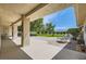 Spacious covered patio with brick accents and a peaceful view of the lush green lawn and distant mountains at 3231 Rebel Ave, Pahrump, NV 89048