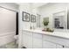 Bathroom featuring double vanity, framed art, and an adjacent closet and shower/tub at 328 Owens Peak Dr, Henderson, NV 89015