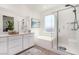 Modern bathroom features double vanity, soaking tub, and glass-enclosed shower at 328 Owens Peak Dr, Henderson, NV 89015
